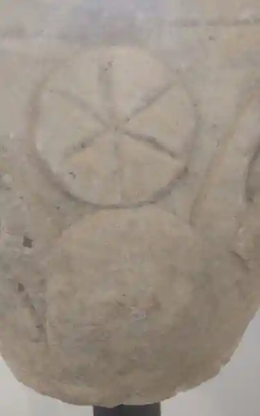 Capital of a pillar, six-point sun symbol, solar disc